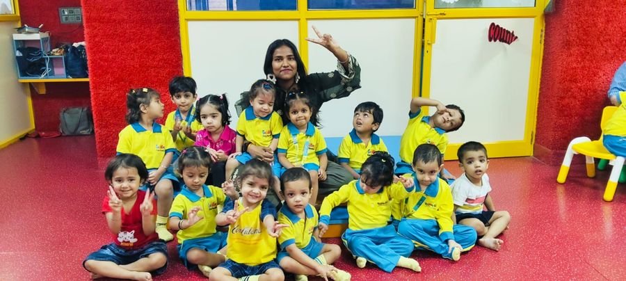 A facilitator with a large group of children posing together
