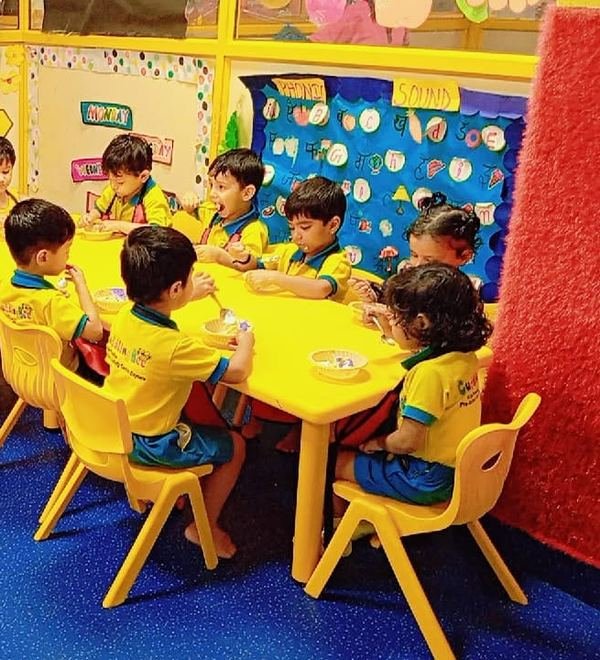 Children eating from bowls at the snack tables